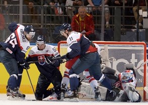 MINSK, BELARUS - MAY 9: Slovakia's Tomas Marcinko #65, Martin Marincin #52 and Peter Ceresnak #11 pounce on a loose puck in the crease during preliminary round action at the 2014 IIHF Ice Hockey World Championship. (Photo by Richard Wolowicz/HHOF-IIHF Images)

