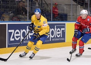 MINSK, BELARUS - MAY 13: Sweden's Dennis Rasmussen #40 stickhandles the puck away from Norway's Andreas Stene #11 during preliminary round action at the 2014 IIHF Ice Hockey World Championship. (Photo by Richard Wolowicz/HHOF-IIHF Images)

