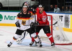 MINSK, BELARUS - MAY 14: Switzerland's Reto Suri #24 battles for position with Germany's Kai Hospelt #18 whiel Rob Zepp #72 attempts to follow the play during preliminary round action at the 2014 IIHF Ice Hockey World Championship. (Photo by Andre Ringuette/HHOF-IIHF Images)

