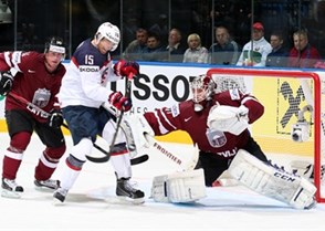 MINSK, BELARUS - MAY 15: USA's Craig Smith #15 with a scoring chance against Latvia's Kristers Gudlevskis #50 while Jekabs Redlihs #14 looks on during preliminary round action at the 2014 IIHF Ice Hockey World Championship. (Photo by Andre Ringuette/HHOF-IIHF Images)


