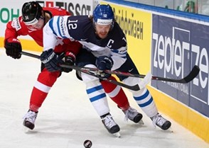MINSK, BELARUS - MAY 16: Finland's Olli Jokinen #12 and Switzerland's Dean Kukan #34 battle for the puck during preliminary round action at the 2014 IIHF Ice Hockey World Championship. (Photo by Andre Ringuette/HHOF-IIHF Images)

