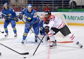 MINSK, BELARUS - MAY 18: Canada's Joel Ward #42 reaches for the puck in front of Sweden's Erik Gustafsson #29 during preliminary round action at the 2014 IIHF Ice Hockey World Championship. (Photo by Richard Wolowicz/HHOF-IIHF Images)