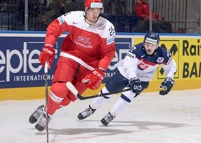 MINSK, BELARUS - MAY 20: Denmark's Oliver Lauridsen #25 stickhandles the puck with  Slovakia's Martin Reway #77 chasing during preliminary round action at the 2014 IIHF Ice Hockey World Championship. (Photo by Richard Wolowicz/HHOF-IIHF Images)

