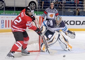 MINSK, BELARUS - MAY 22: Canada's Joel Ward #42 reaches for a loose puck in front of Finland's Pekka Rinne #35 during quarterfinal round action at the 2014 IIHF Ice Hockey World Championship. (Photo by Richard Wolowicz/HHOF-IIHF Images)
